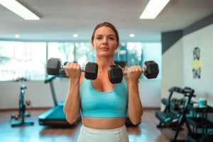 Woman lifting two dumbbells